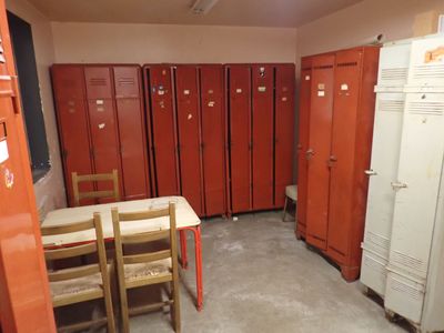 de nombreux casiers rouges dans une pièce équipée d'une table et de chaises