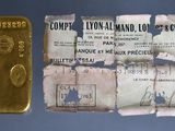 a gold bar and a piece of paper on a table