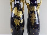 two vases that are sitting on a table
