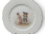 a white plate with a picture of two children on it