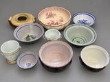 many different types of bowls and cups on the table