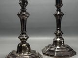 pair of silver candlesticks on a white background