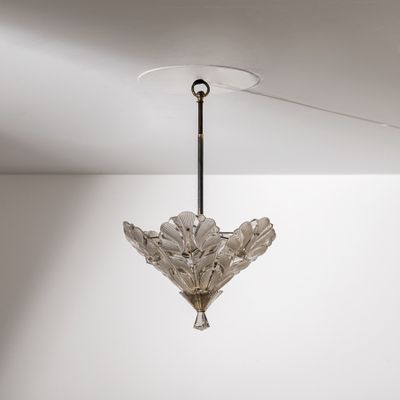 a glass chandelier hanging from the ceiling in a room