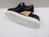 a close up of a pair of black sneakers on a white surface