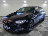 the black opel is parked in a room with a checkered floor
