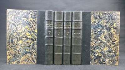 a set of four books with gold and black covers on them