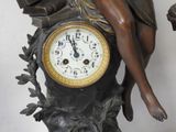 a statue of a woman sitting on top of a clock