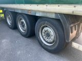 a green semi truck that is parked on the side of the road