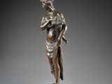 bronze statue of a woman holding a child on a marble base