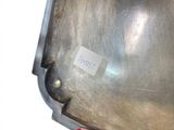 a person holding a piece of metal with a sticker on it