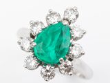 an emerald and diamond cluster ring