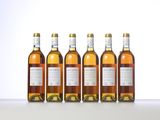 four bottles of wine are lined up on a table