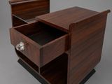 a wooden nightstand with a drawer on top of it