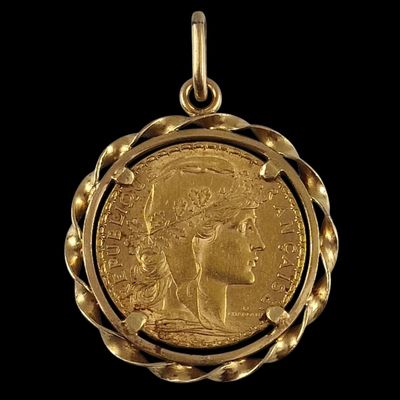 a close up of a gold coin on a black background