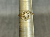 a gold ring sitting on top of a silver pole