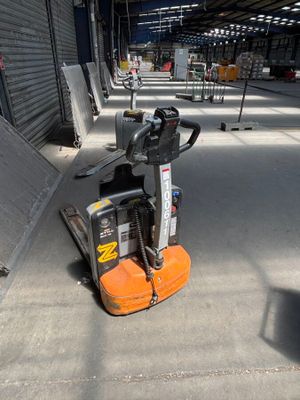a forklift that is parked in a warehouse