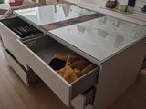 a glass table with a drawer in the middle of it
