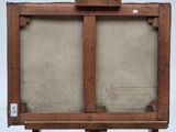 an old wooden easel with a painting on top of it