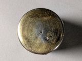 a close up of a small metal object on a table