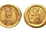 a gold coin with an image of a man and a woman on it