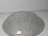 a glass bowl with a lid sitting on a table