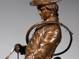 statue of a man riding a horse with a lasset on his head
