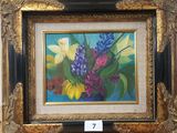 une photo d'un tableau de fleurs dans un cadre doré