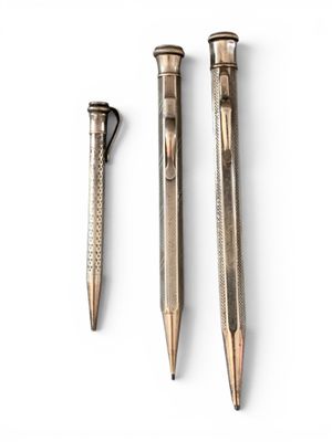 three different types of pens sitting next to each other on a white surface