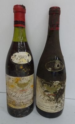 two bottles of wine sitting next to each other on a table