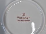 a close up of a white plate with a red logo on it