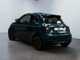 the small car is parked in a large room with a clock on the wall