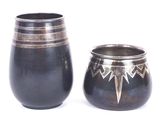 two vases sitting next to each other on a white surface
