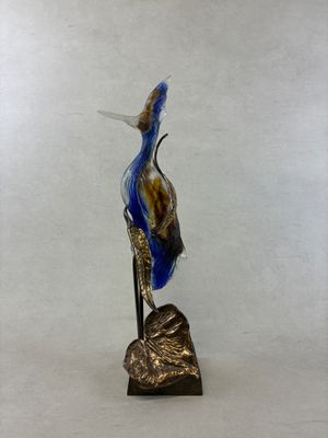 statue of a bird on a rock on a white background