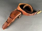 an old pair of brown leather shoes with a leather strap