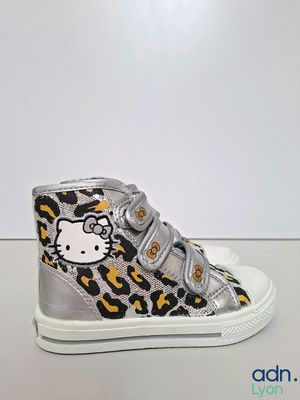 a close up of a pair of hello kitty shoes on a table