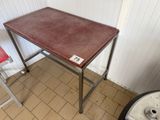 a small table with a red chair next to it