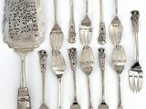 a lot of silver spoons and forks on the table