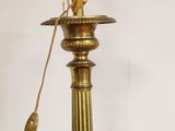 a lamp that is sitting on a table next to a wall