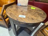 a wooden table with a sign on it in a store
