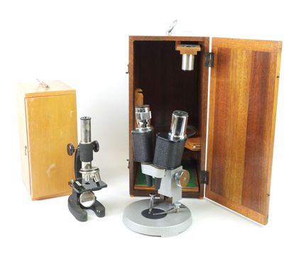 two microscopes and a box on a white surface