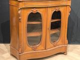 a wooden cabinet with two glass doors on it