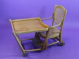 a small child ' s high chair with a tray on it