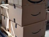 boxes stacked on a pallet with a fan in the background