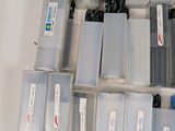 a lot of plastic boxes with different types of pens and pencils