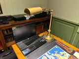 a laptop computer sitting on a desk in front of a map
