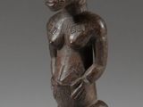 a wooden statue of a man with a hat on his head