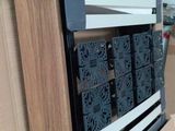 a stack of books on top of a cardboard box in a room