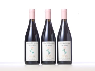 three bottles of wine are lined up on a table
