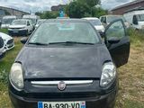 a black car parked in a lot with other cars in the background