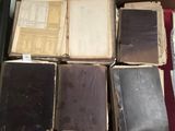 many old books sitting on a red table
